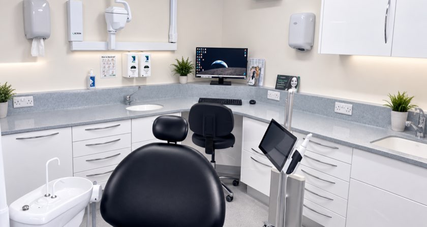 A treatment room set up for implant surgery, with the chair, screen and instruments ready.