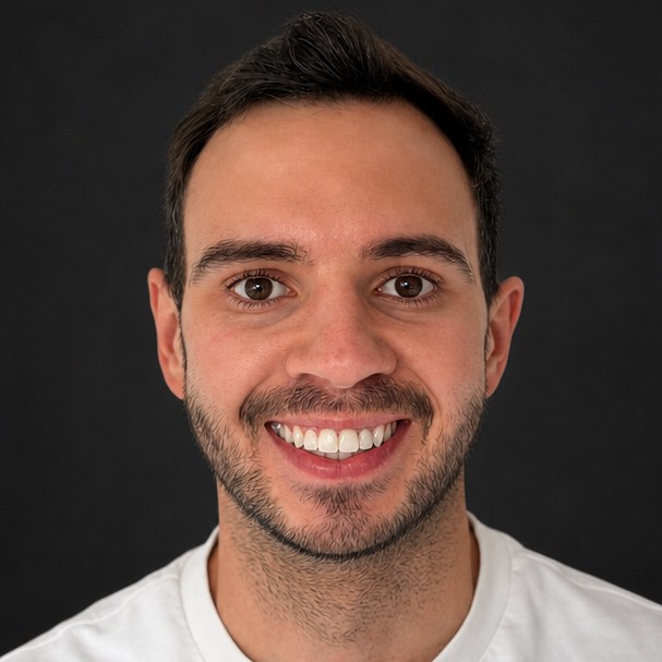 Portrait of Darren smiling after treatment, against a dark background.